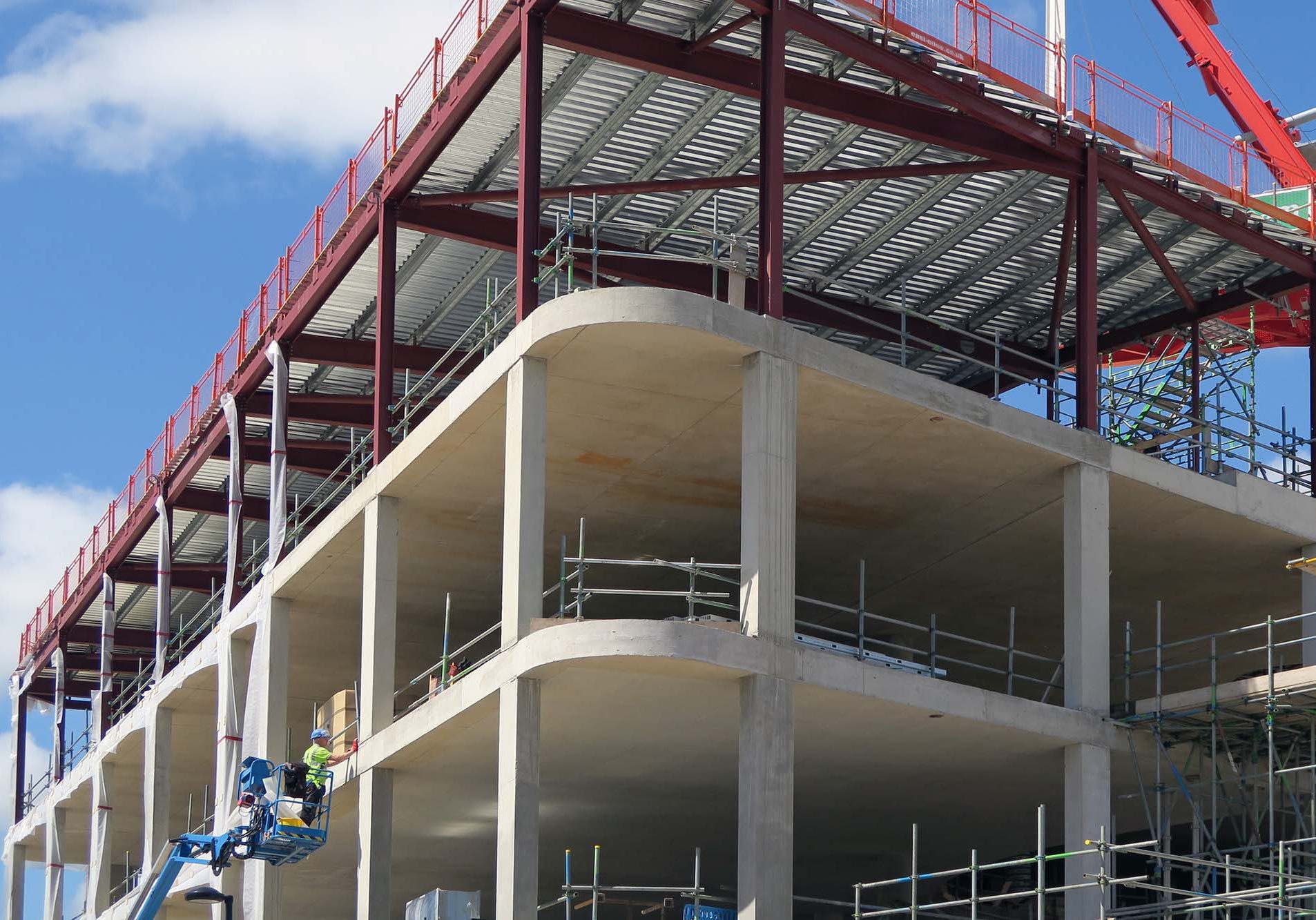 YORK, North Yorkshire, UK: Circa August 2015 - Construction engineer uses platform picker to work on shell of new building.